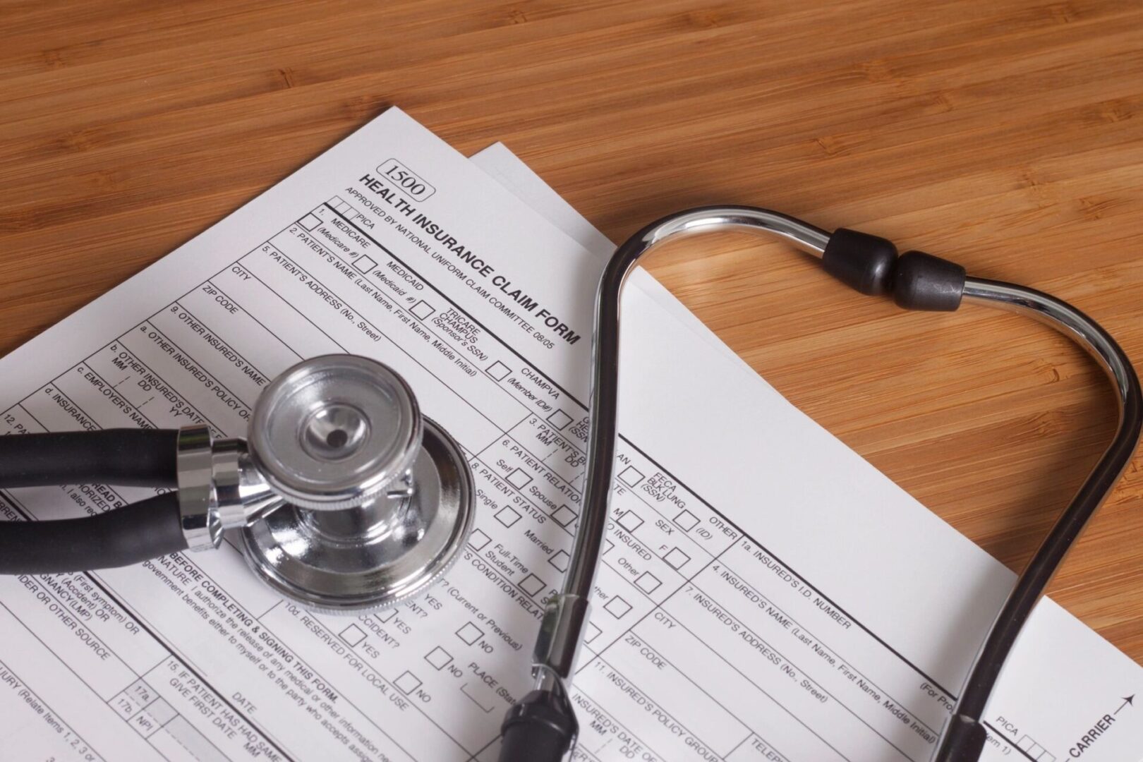 A stethoscope sitting on top of papers.