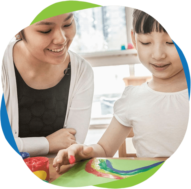 A woman and child are painting with markers.