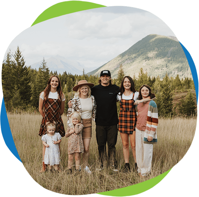 A group of people standing in the grass.